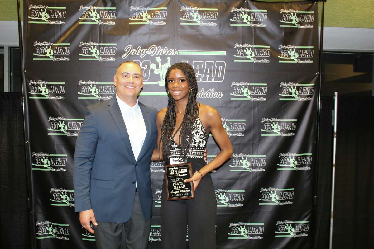 Midland High's Aniya Clinton is presented the Volleyball Player of the Year Award by 33 Lead Foundation President Joe Flores at the foundation's award ceremony on Sunday at the Horseshoe Arena.