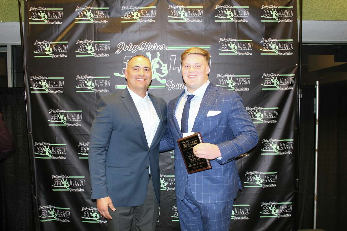 Odessa Permian's Harris Sewell is presented his Football Player of the Year award by 33 Lead Foundation President Joe Flores at the foundation's award ceremony on Sunday at the Horseshoe Arena.