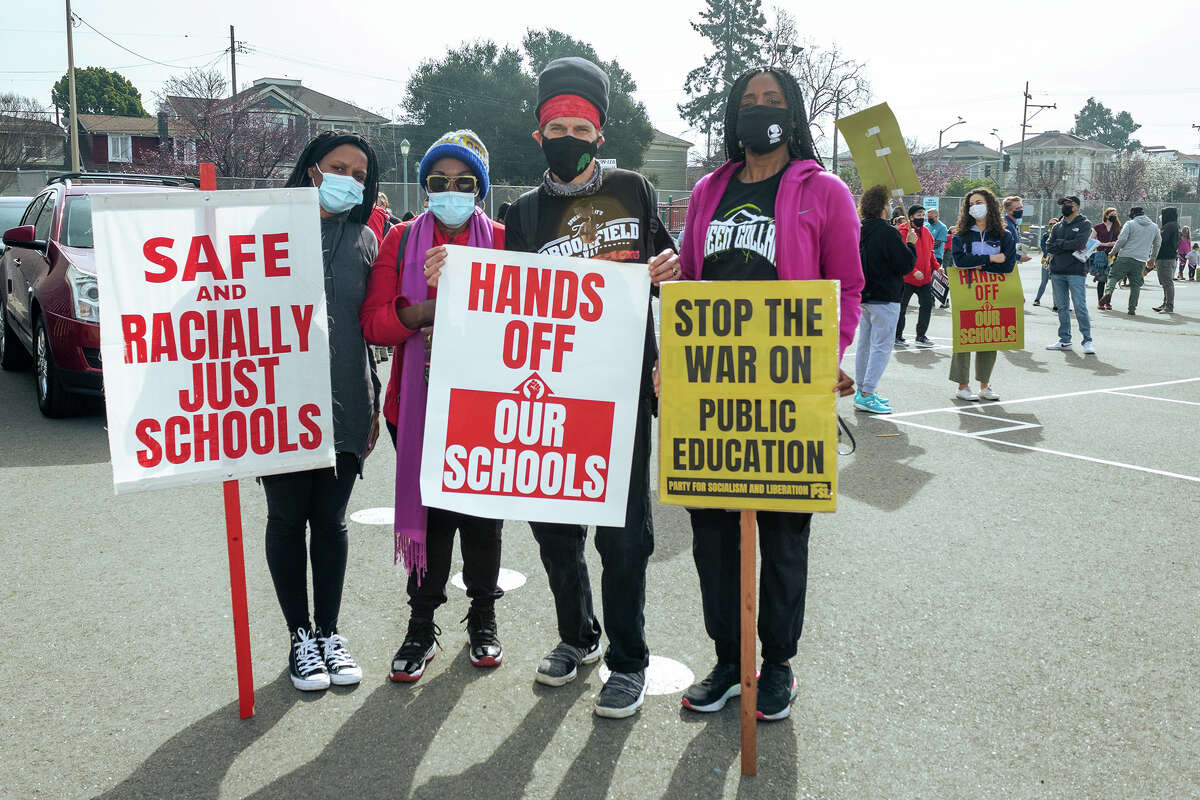 Left to right: Haley Hester, Felisha West, 25 year OUSD teacher Corrin Haskell, and Oakland District 7 Councilmember Treva Reid stand togother against OUSD school closures at the Oakland School Solidarity Rally and 4Peace Community Walk, on Feb. 5, 2022.