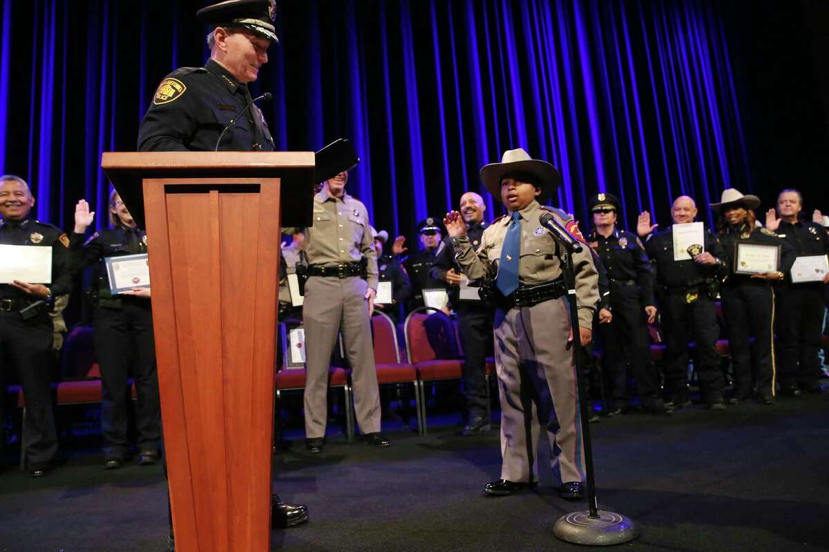 Ten-year-old Devarjaye “D.J.” Daniel is sworn in as honorary law enforcement officer by San Antonio Police Chief William McManus during a ceremony at Community Bible Church on Monday, Feb. 7, 2022. More than 40 local and area law enforcement agencies participated in the event. The Freeport, Texas, child has been diagnosed with terminal cancer.