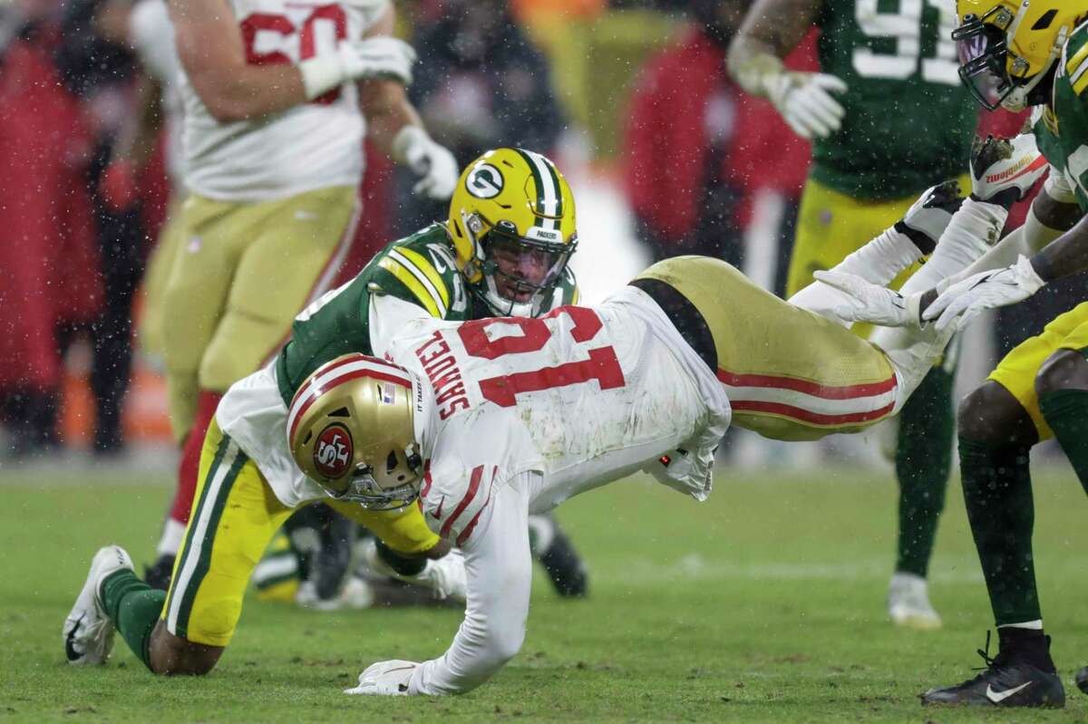 Green Bay Packers' Rasul Douglas stops San Francisco 49ers' Deebo Samuel during the second half of an NFC divisional playoff NFL football game Saturday, Jan. 22, 2022, in Green Bay, Wis. (AP Photo/Matt Ludtke)