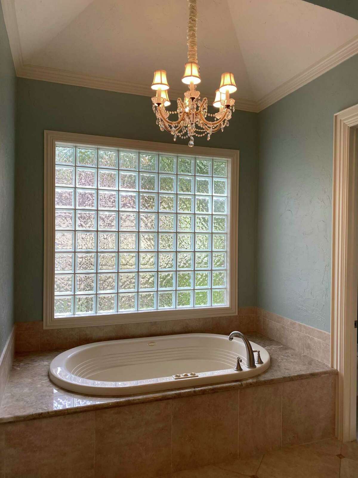Before: The built-in bathtub dated the house to its 2003 origin. and the glass-block window was never a good idea.
