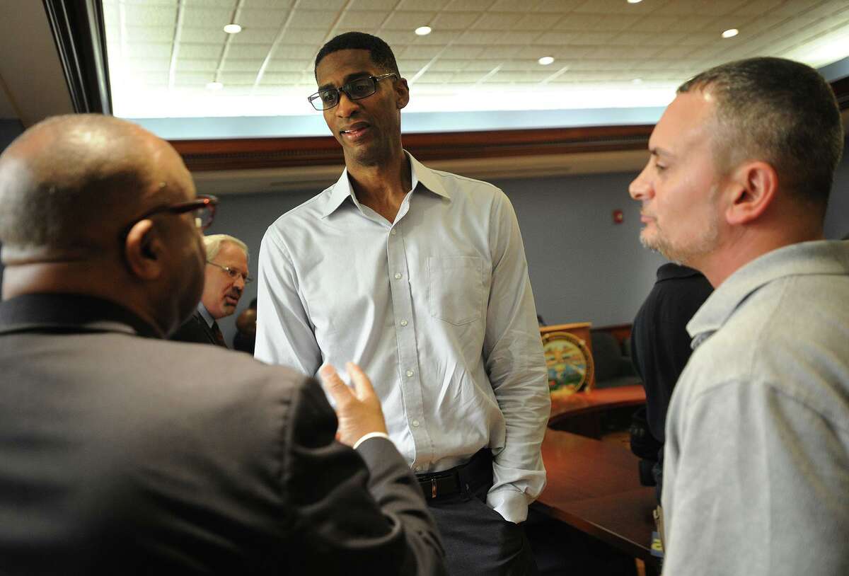 Former NBA basketball player and Bridgeport native Charles Smith, center, speaks with Family Re-Entry residential program manager Fred Hodges, left, and Daee McKnight during the kickoff of the Mayor's Initiative on Re-Entry Affairs at City Hall Annex in Bridgeport, Conn. on Monday, August 8, 2016. The program looks to assist ex-felons with finding employment with city businesses after their release from prison.