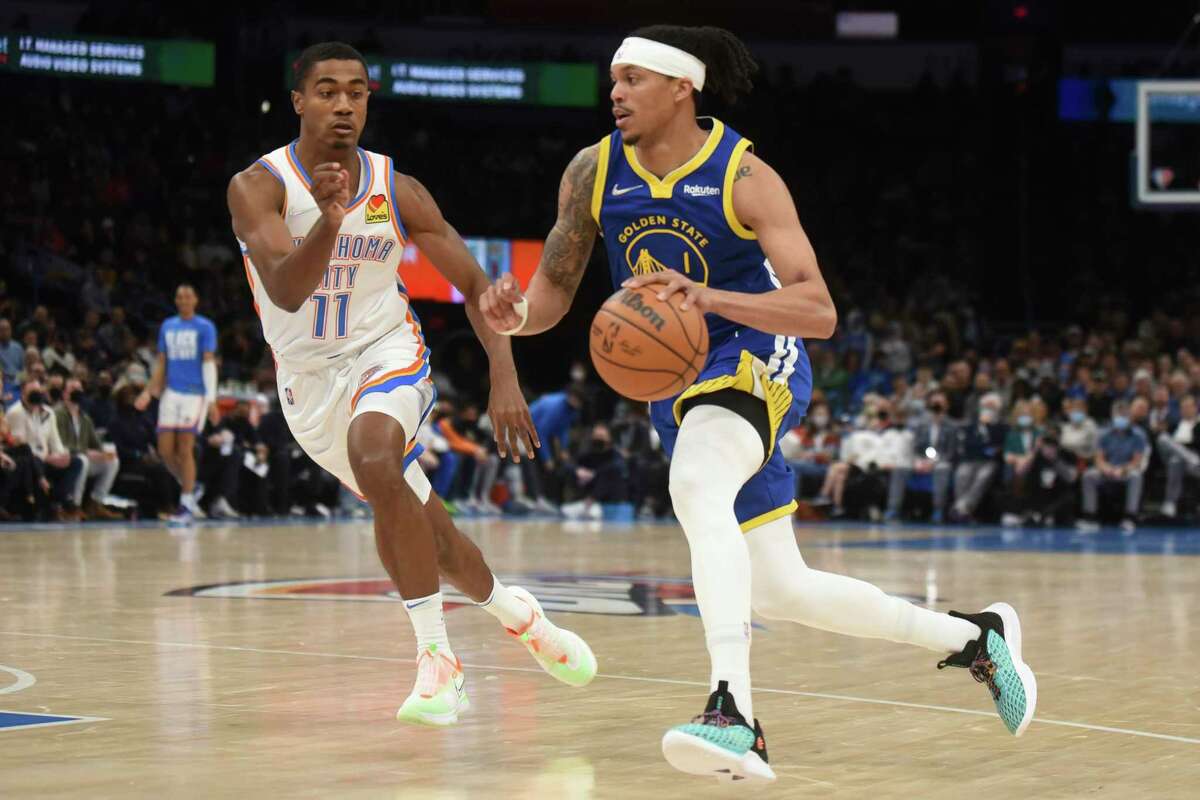 Golden State Warriors guard Damion Lee (1) pushes past Oklahoma City Thunder guard Theo Maledon (11) in the first half of an NBA basketball game, Monday, Feb. 7, 2022, in Oklahoma City. (AP Photo/Kyle Phillips)
