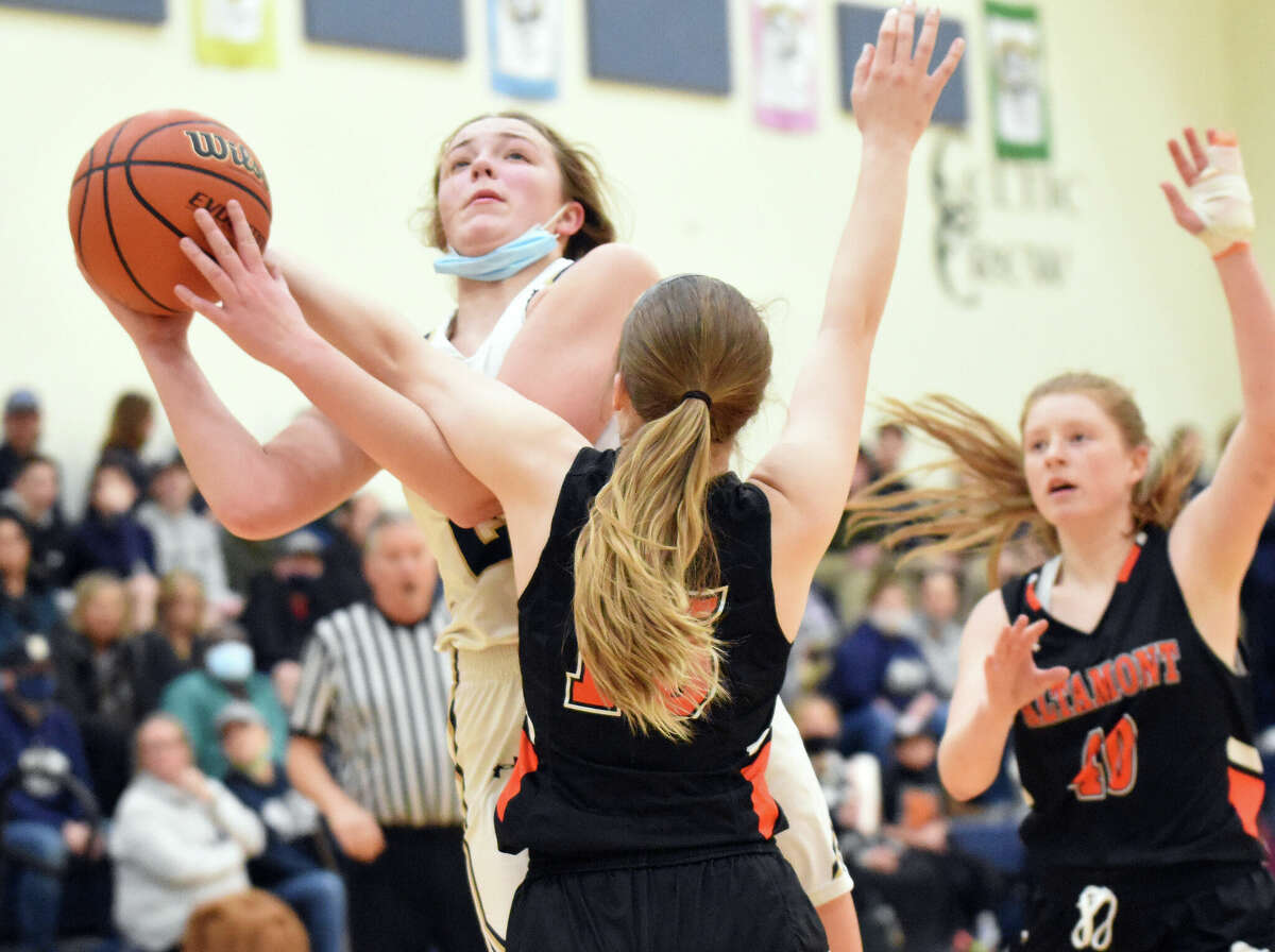 Father McGivney's Charlize Luehmann is fouled on a shot attempt during the first half against Altamont in Glen Carbon.
