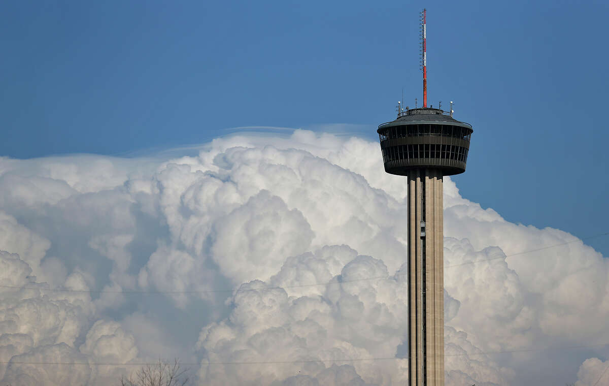 Storm clouds are pictured behind the Tower of the Americas on Sunday, March 18, 2018.