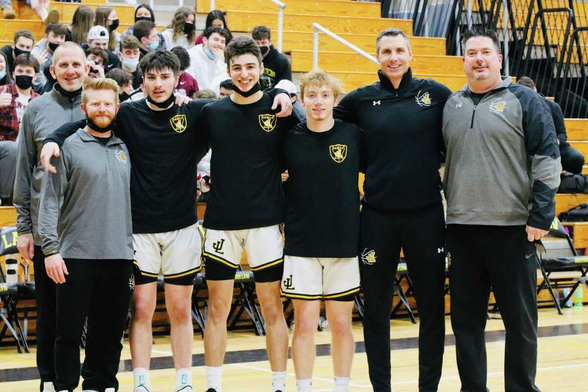 Law assistant coach Rob McKenna Hansen, assistant Matt McPartland, Daniel Maxwell, Anthony Andriolas, Spencer Hannon, head coach Jamie Anderson and Dan Maxwell get together on Senior Night.