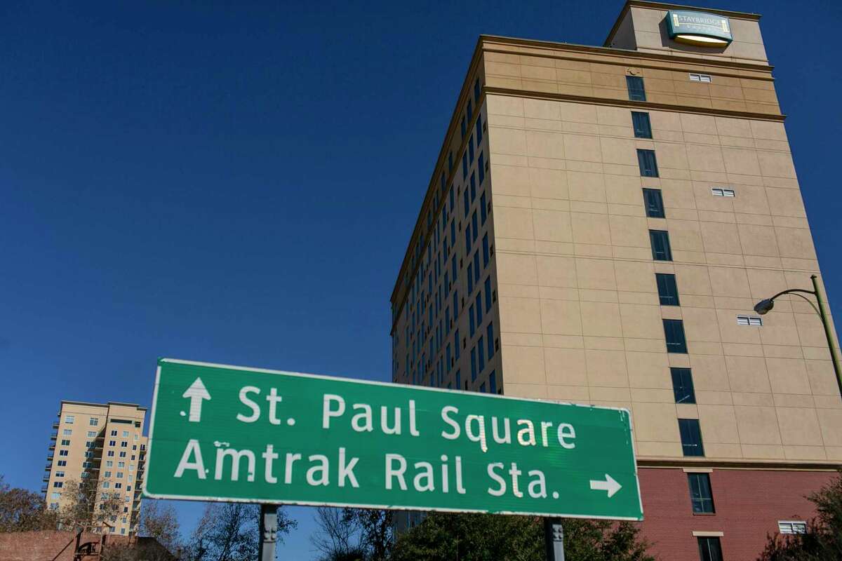 The group trying to turn St. Paul Square into a nightlife destination has purchased the 11-story Staybridge Suites with plans to renovate the hotel.