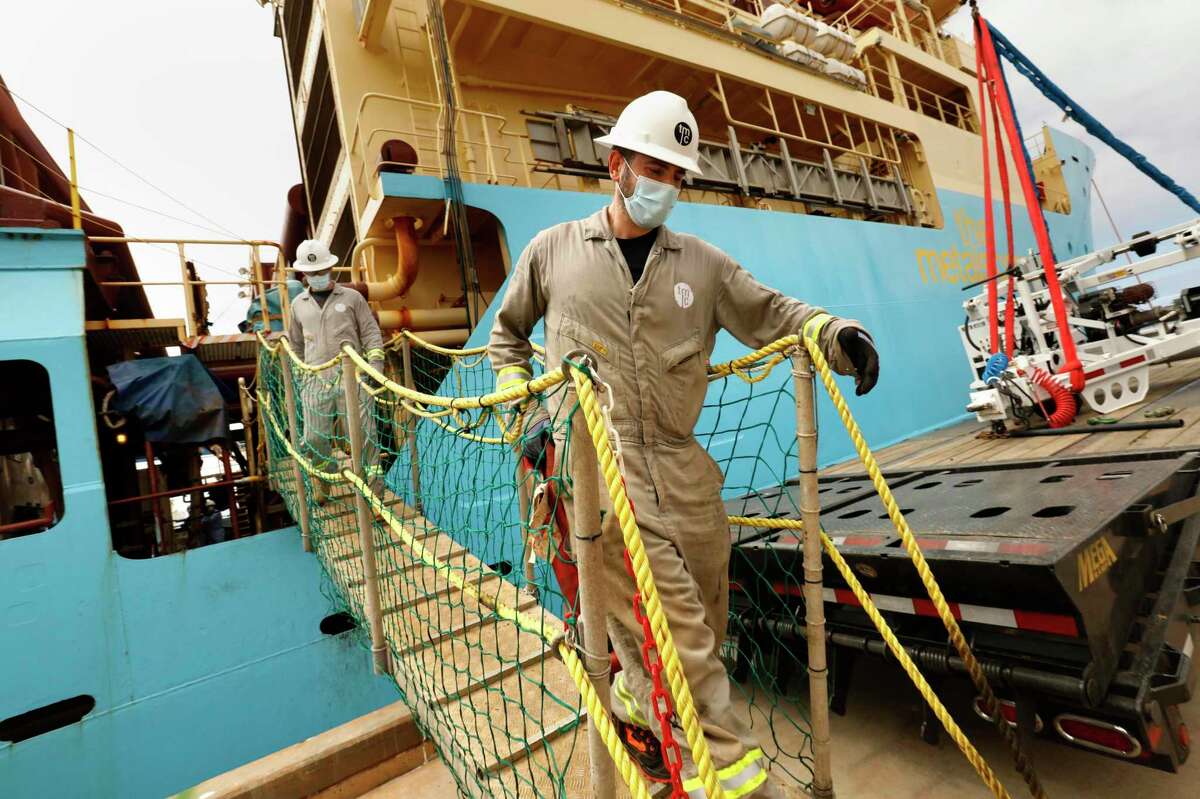 Workers disembark from the research vessel that had returned to San Diego last June from the Clarion Clipperton Zone of the Pacific Ocean, where soil, water, and wildlife samples were obtained from deep in the ocean as part of the research to determine the effects mining will have on the environment.
