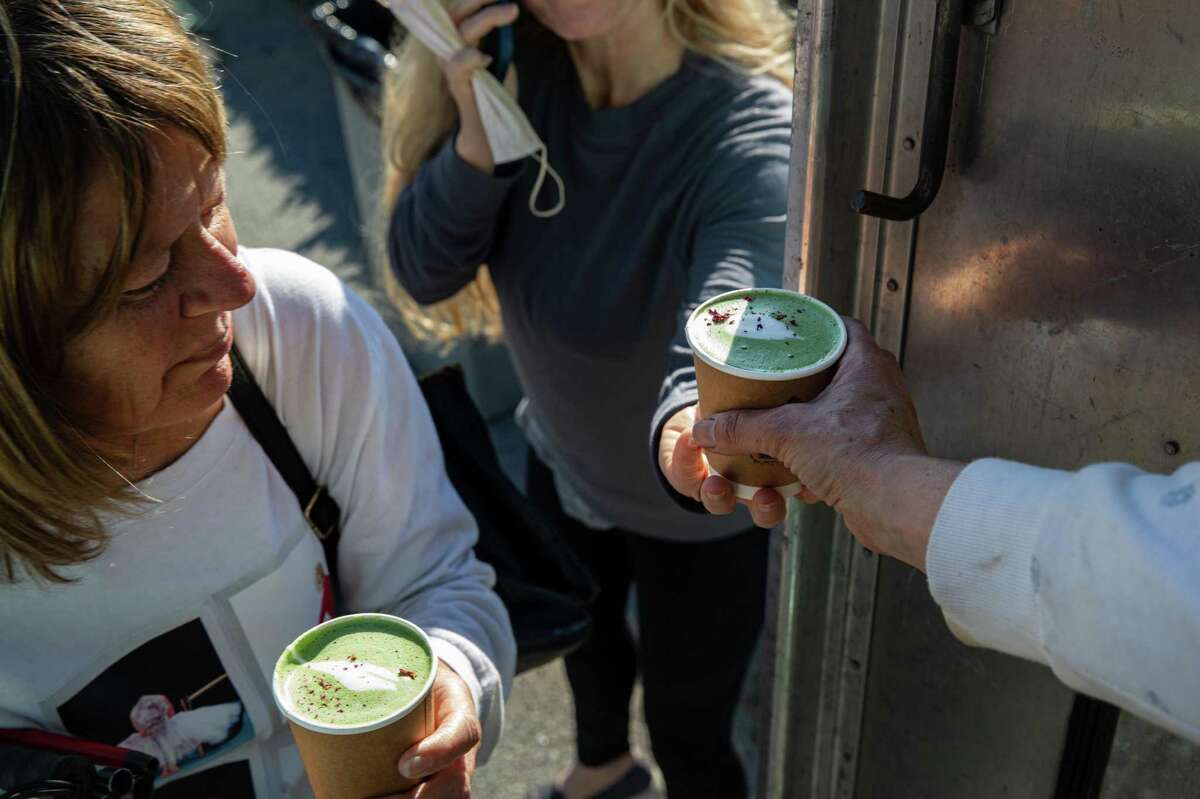 Molly Welton, owner of California Kahve, hands a matcha rose latte to customers Nikita Stewart (left) and Sheila Butler. Welton’s truck has been parked on the Great Highway at Taraval Street on Saturdays and Sundays.