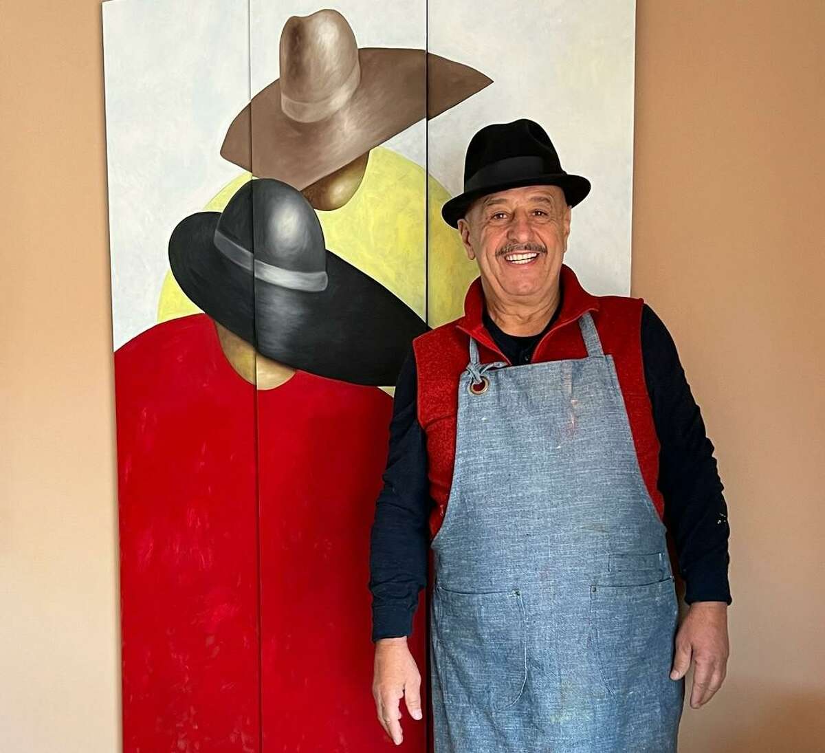 Pictured is Guilloume, the featured artist for The Fidelity Investments The Woodlands Waterway Arts Festival set for April 8-10, standing next to his featured original art “Celebrating Abundance.”