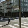 San Francisco, California - February 3rd, 2022: A pedestrian walks across the street in Pac Heights. A new study revealed that crosswalks are very inequitable across San Francisco.