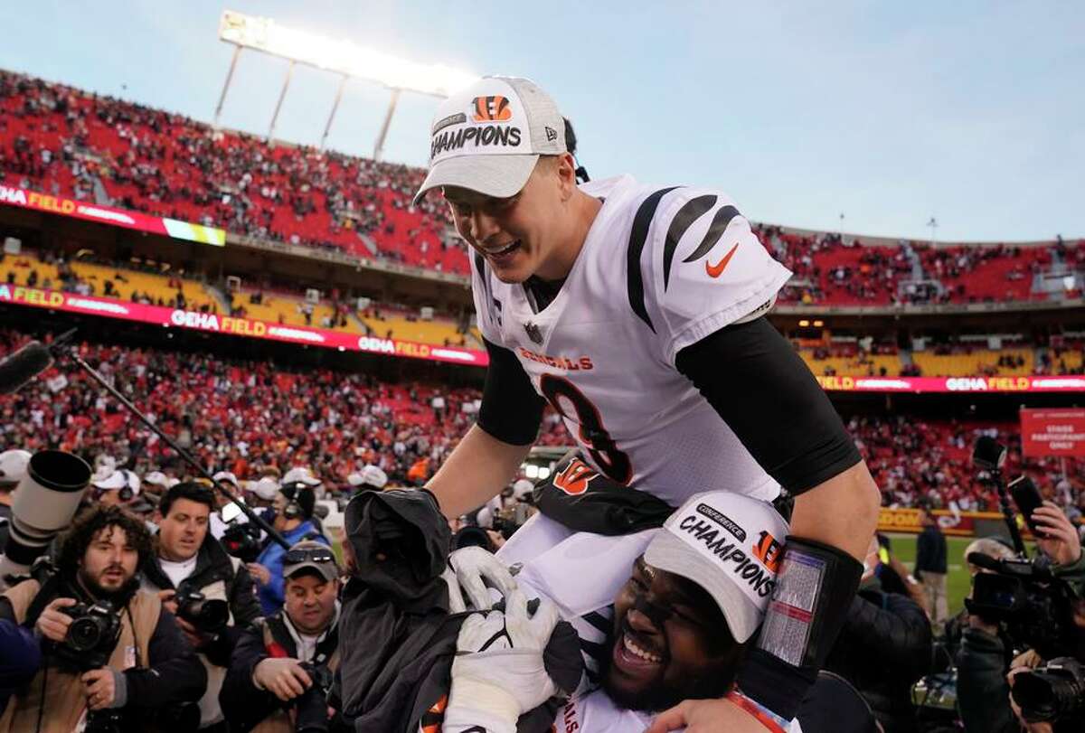 Quarterback Joe Burrow gets a lift from teammates after the Bengals beat Kansas City in the AFC Championship Game.