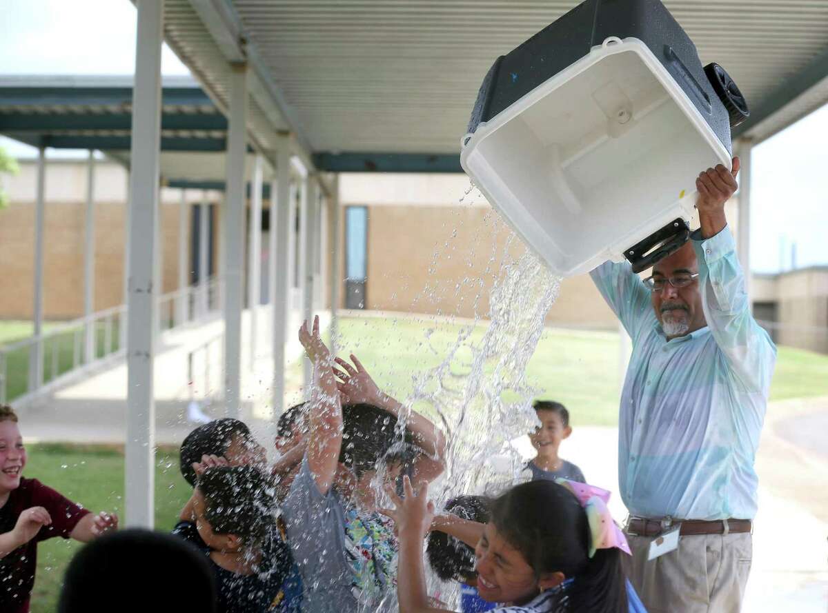 Somerset Elementary School teacher Jesus Gutierrez pours the last remaining water on his third-grade students at an end-of-year water balloon splash day in 2019.