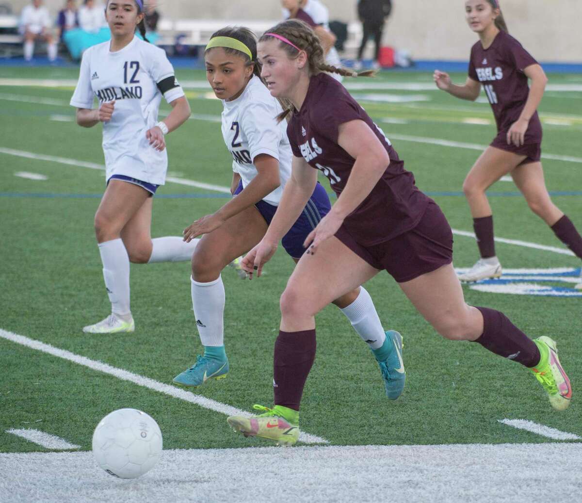 Legacy High's Rylee Low brings the ball up the sideline as Midland High's Anahy Grimaldo chases her 02/08/2022 at Grande Communications Stadium. Tim Fischer/Reporter-Telegram