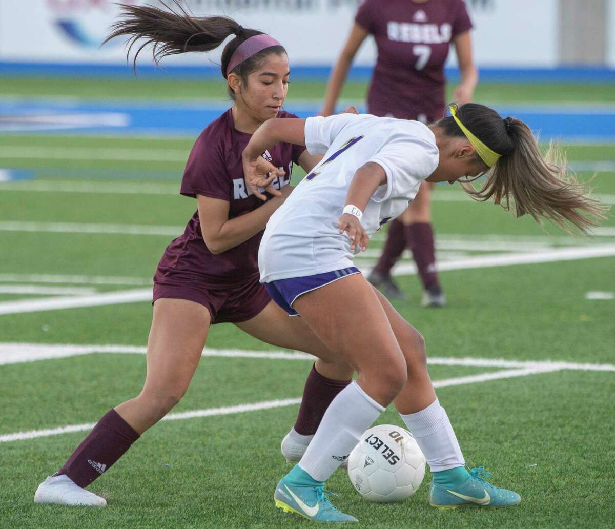 Midland High's Anahy Grimaldo battles for control of the ball with Legacy High's Alyssa Ortega 02/08/2022 at Grande Communications Stadium. Tim Fischer/Reporter-Telegram