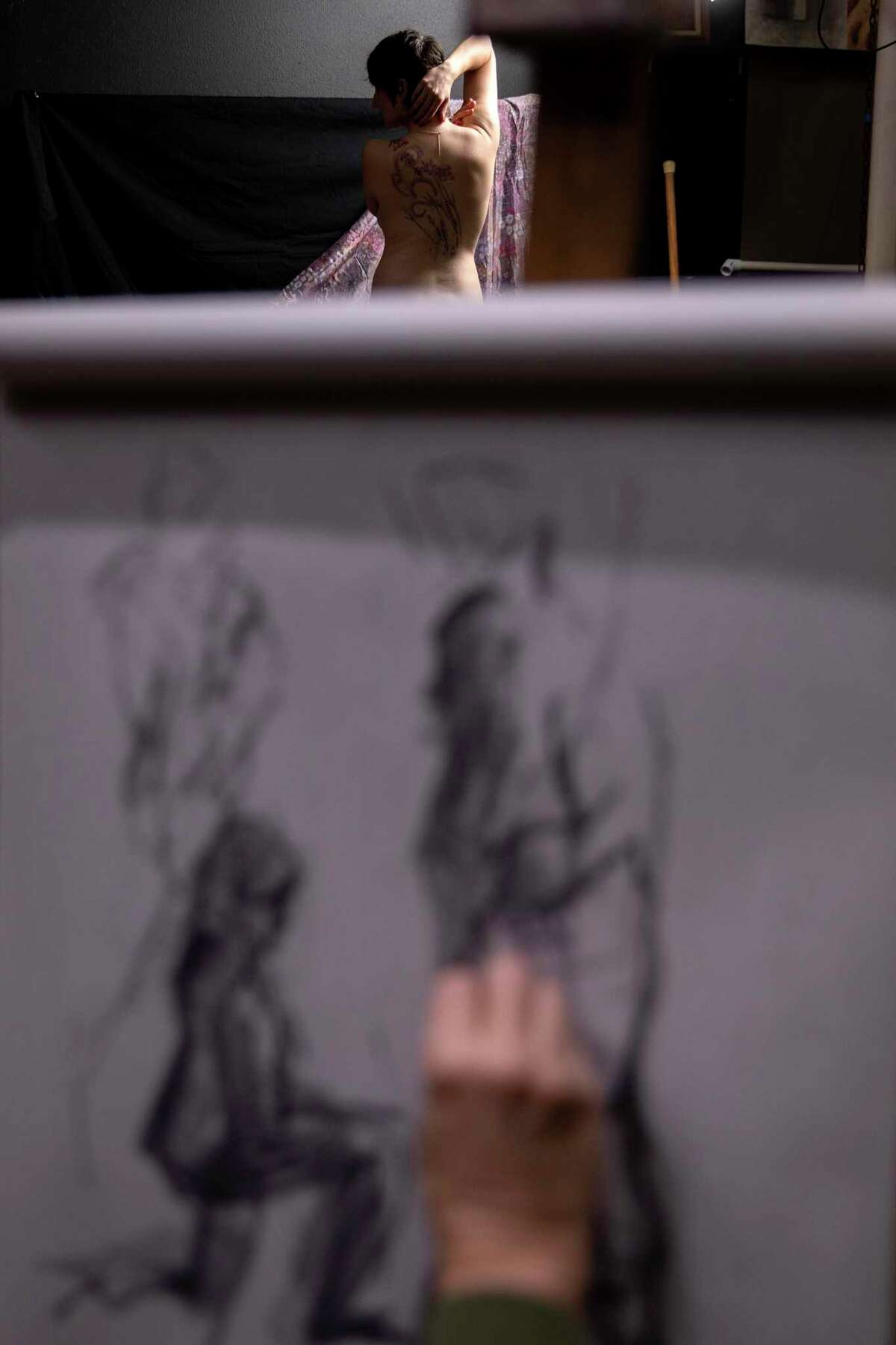 Dana Buzzelli poses for artists at the Coppini Academy of Fine Arts during a nude figure drawing class.