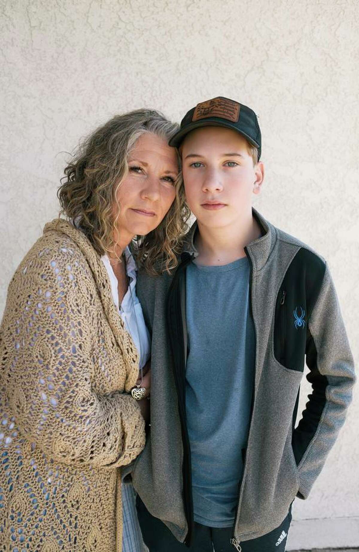 Kathy Stainbrook (left) with her son Caleb. Stainbrook, who helped with the recall, says the pandemic restrictions in schools were what disturbed her most.