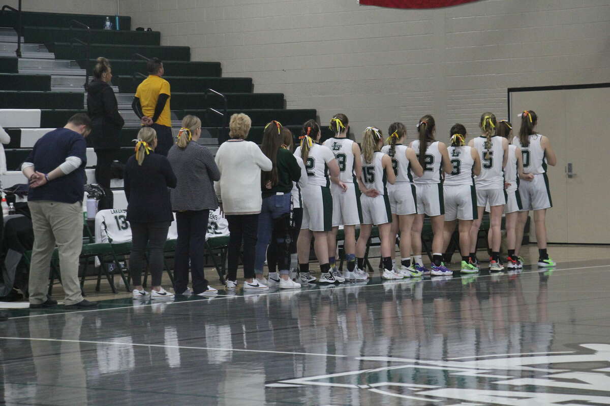 The Lady Lakers line up for the National Anthem.