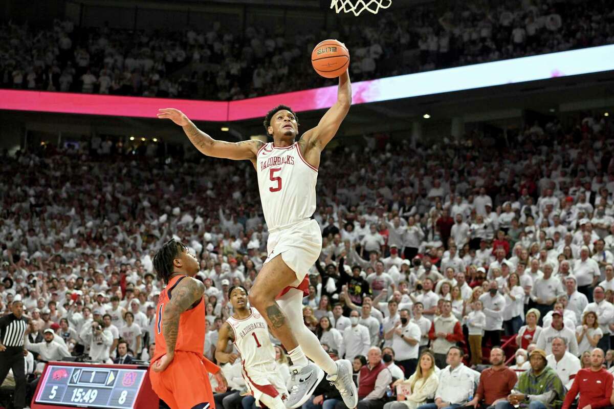 Arkansas guard Au'Diese Toney (5) gets past Auburn guard Wendell Green Jr. (1) to score on a fast break during the first half of an NCAA college basketball game Tuesday, Feb. 8, 2022, in Fayetteville, Ark. (AP Photo/Michael Woods)