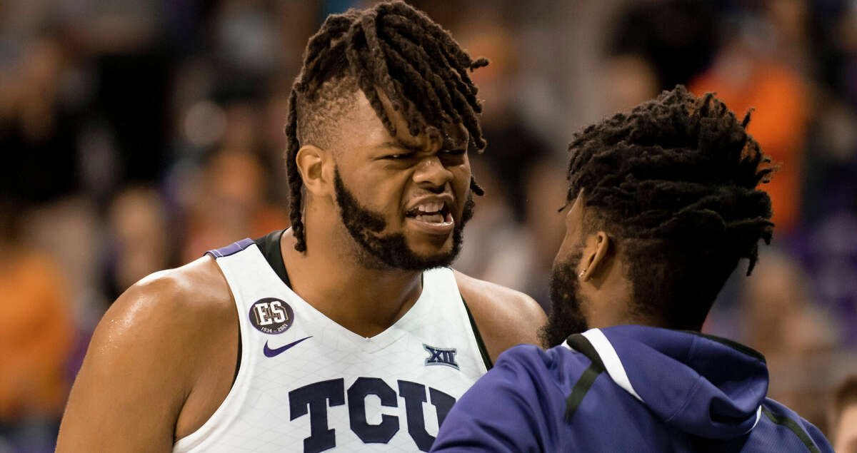 TCU center Eddie Lampkin Jr. (4) celebrates with TCU guard Mike Miles (1) after hitting two free throws in the second half of an NCAA college basketball game against Oklahoma State in Fort Worth, Texas, Tuesday, Feb. 8, 2022. (AP Photo/Emil Lippe)