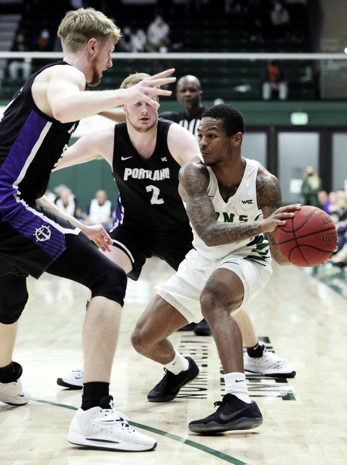 Khalil Shabazz (0) drives to the basket in the first half as the University of San Francisco Dons played the Portland Pilots at War Memorial Gym in San Francisco, Calif., on Tuesday, February 8, 2022.