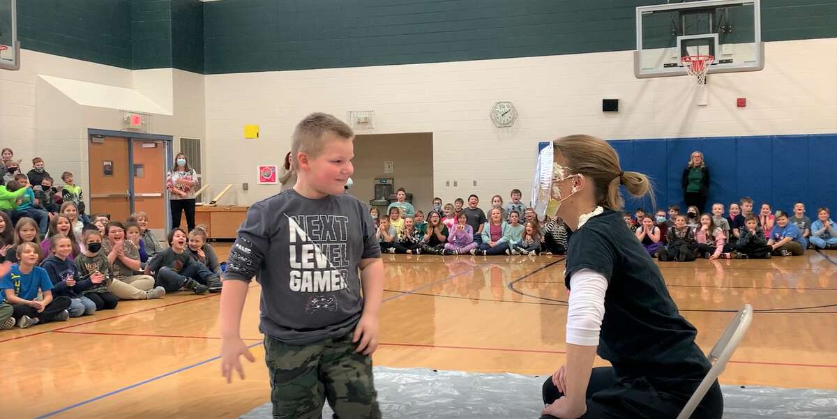 Kindergartner Ajay Langley was one of the students chosen to throw a pie in Rebecca Krohn's face.