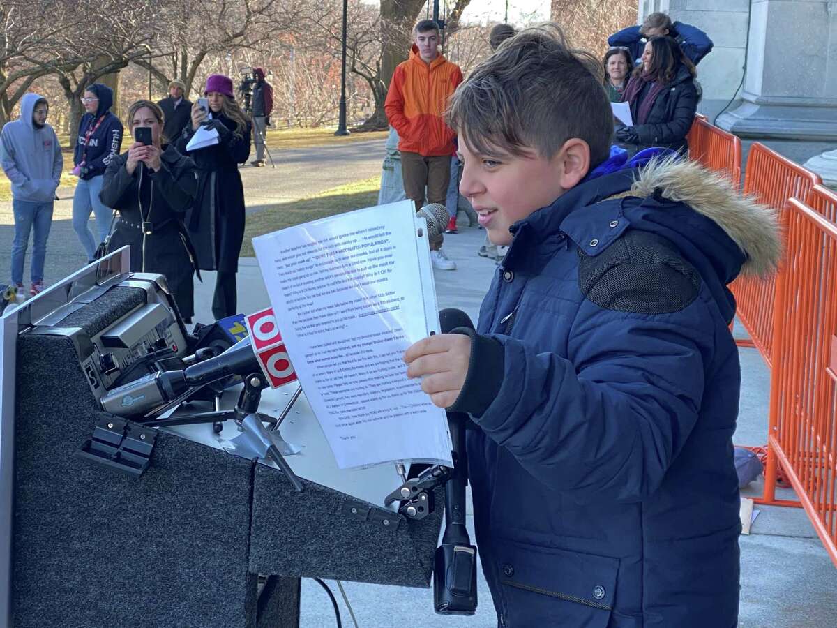 Hamden fifth-grader Alexios Selearis, on the steps of the State Capitol on Wednesday, shouted that the face mask mandate has drastically affected his daily interactions with school personnel.