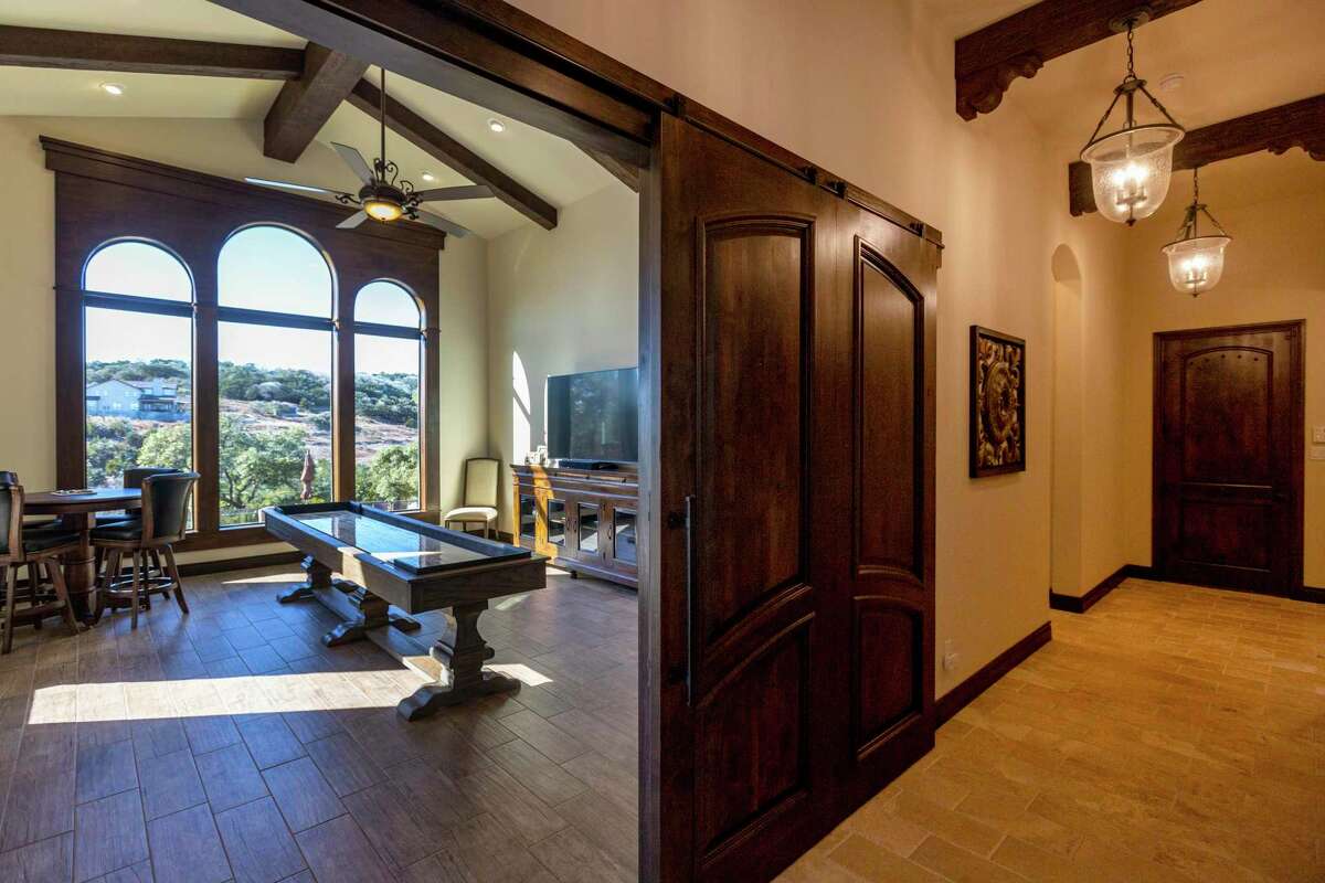 The games room overlooks the backyard with a view of the houses across a shallow valley.