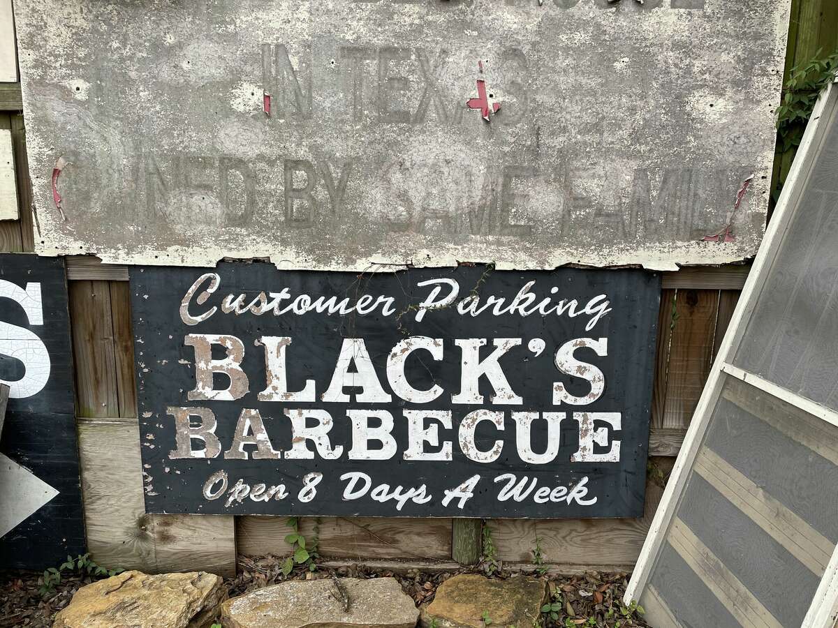 The backyard at Black's features an array of vintage signs.