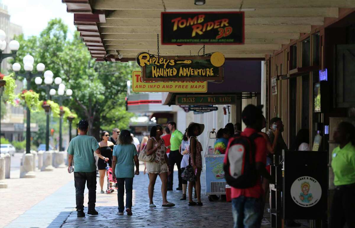 People walk near Ripley's Haunted Adventure across from the Alamo in this 2018 photo.