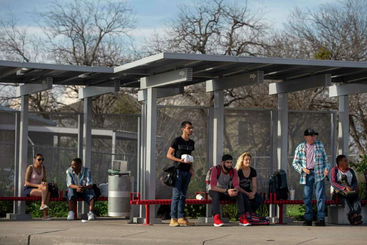 People wait for their bus at a VIA bus stop on East Fredericksburg Road in 2020. VIA’s plans for a city-wide “advanced rapid transit” system featuring more buses running at shorter intervals on dedicated lanes have cleared a federal funding milestone this week.
