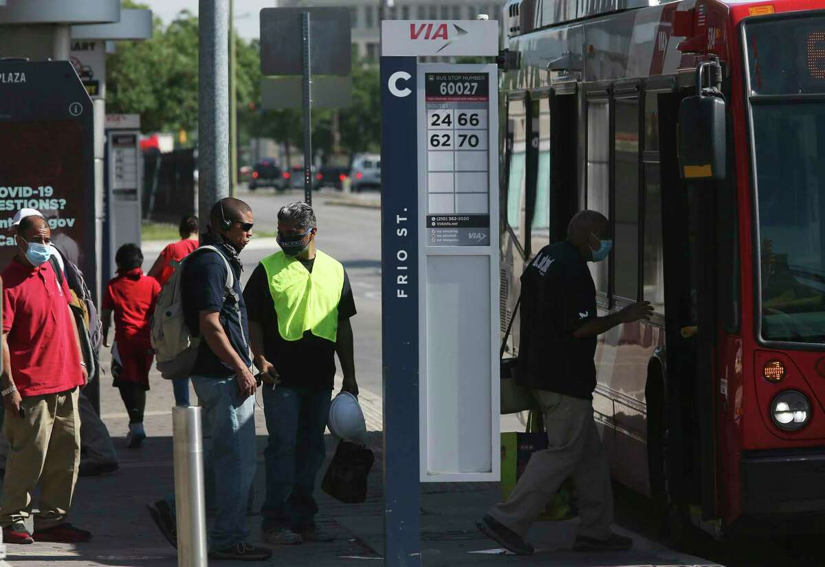 VIA bus passengers, some masked others not, wait to board a bus at VIA Centro Plaza in 2020. VIA’s plans for a city-wide “advanced rapid transit” system featuring more buses running at shorter intervals on dedicated lanes have cleared a federal funding milestone this week.