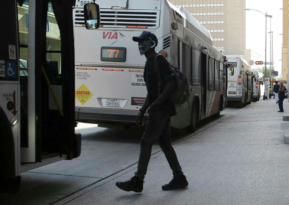A bus rider boards his ride near St. Mary's and Martin Streets in downtown in 2021. VIA’s plans for a city-wide “advanced rapid transit” system featuring more buses running at shorter intervals on dedicated lanes have cleared a federal funding milestone this week.