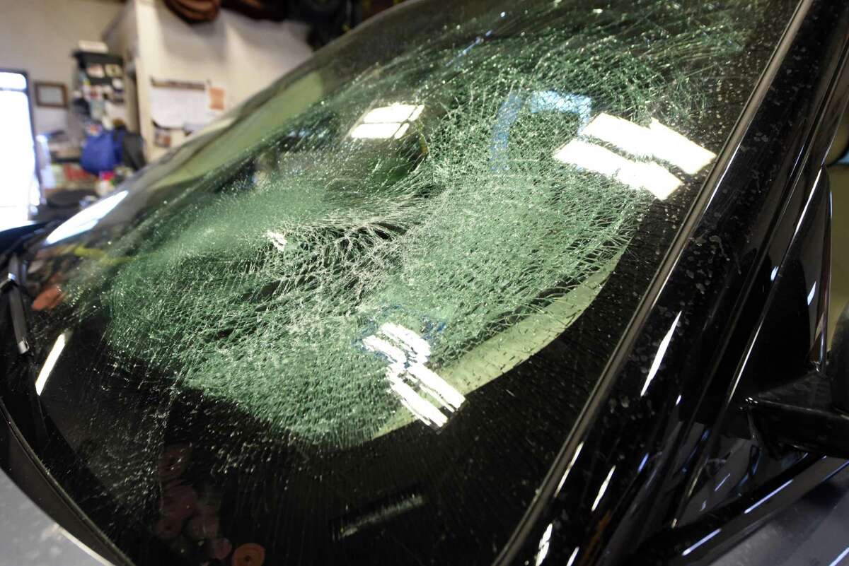 Smashed windshield on a customer’s Range Rover that was destroyed by ice falling off a passing truck is waiting to be replaced at Georges Auto Glass & Upholstery on Wednesday, Feb. 9, 2022, in Colonie, N.Y.