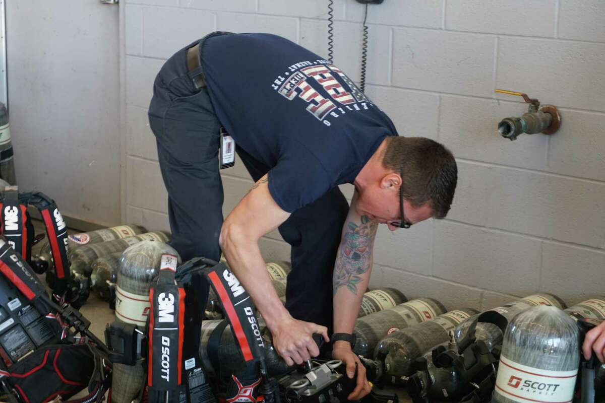 Tad Greenhalgh with the Rosenberg Fire Department moves self-contained breathing apparatus air packs at Rosenberg Fire Station No. 2 on Tuesday, Feb. 8. The 112 air packs were purchased through a regional grant shared by Rosenberg, Needville, Pleak and Fairchilds fire departments.