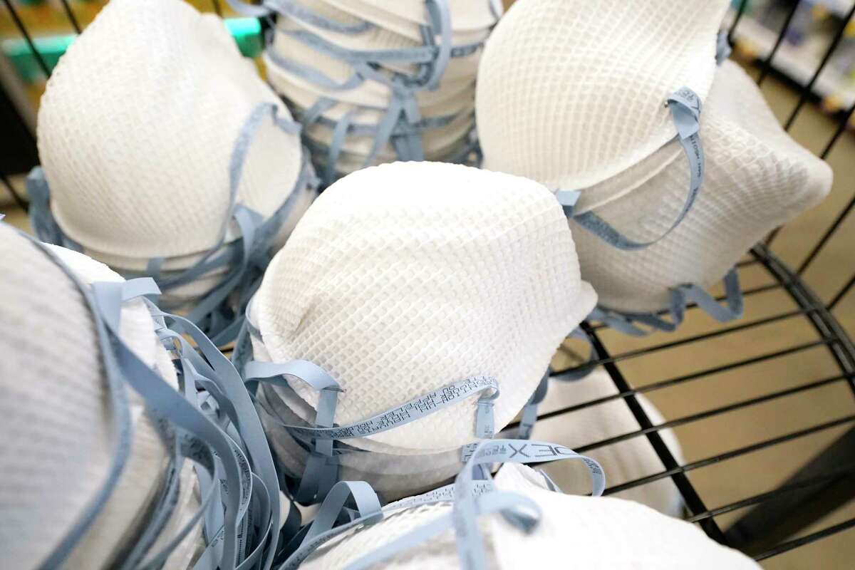A product stall filled with free N95 respirator masks, provided by the U.S. Department of Health and Human Services, sits outside the pharmacy at this Jackson, Miss., Kroger grocery store, Wednesday, Feb. 2, 2022. The Biden administration is making 400 million N95 masks available for free to U.S. residents. Authorities note the masks' offer better protection against the omicron variant of COVID-19 than cloth masks. (AP Photo/Rogelio V. Solis)