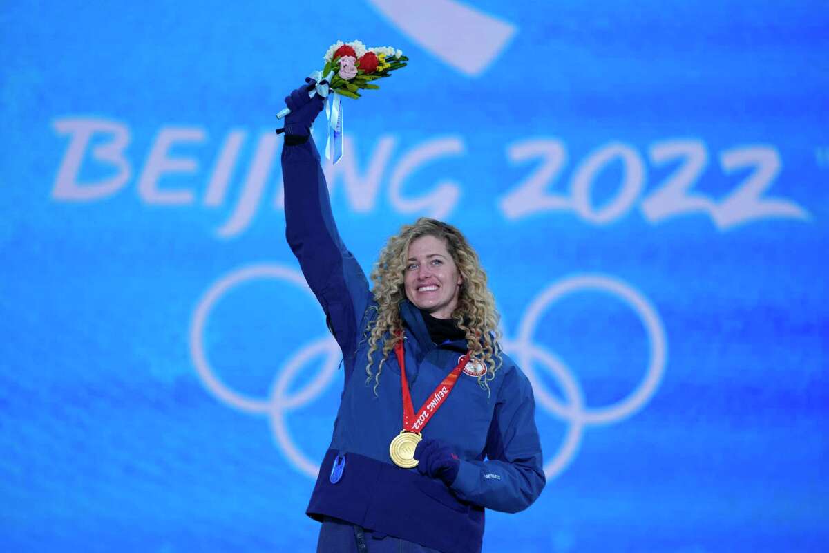 Lindsey Jacobellis acknowledges the crowd during a medal ceremony for the women's snowboard cross finals competition at the 2022 Winter Olympics, Wednesday, Feb. 9, 2022, in Zhangjiakou, China. (AP Photo/Frank Augstein)