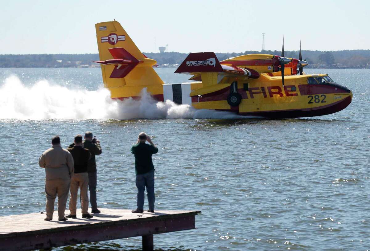 Onlookers watch as Bridger Aerospace demonstrate their new fully amphibious aircraft used for aerial firefighting over Lake Conroe, Wednesday Feb. 9, 2022.