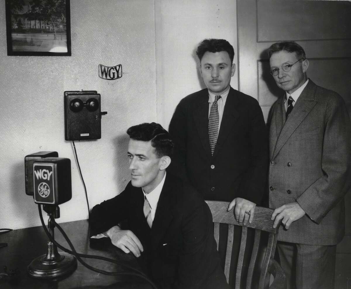Harold Gatty, aviator Wiley Post, standing, and Mr. P. Rice (G.E. Company), WGY radio. July 20, 1931 (Times Union Archive)