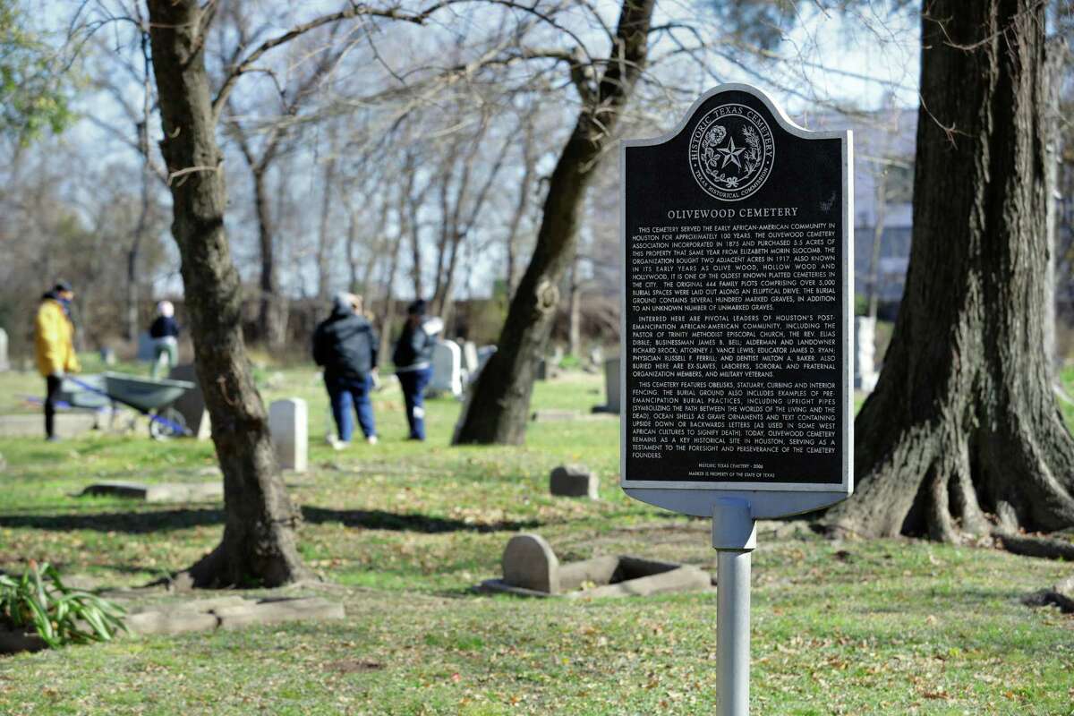 The 2006 historical marker at the entrance to the historically black Olivewood cemetery Saturday, Feb. 5, 2022 in Houston, TX. Some five volunteers spent the morning weed whacking, raking leaves and doing general clean up across the cemetery.