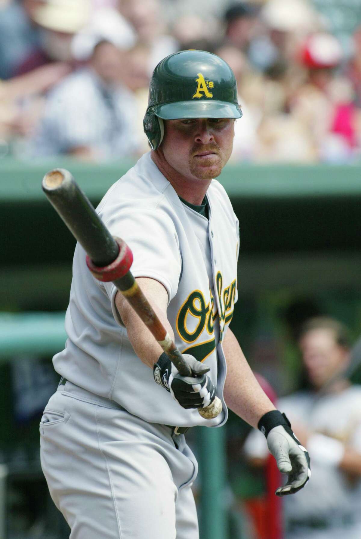 ARLINGTON, TEXAS - APRIL 11: Left fielder Jeremy Giambi #7 of the Oakland Athletics warms up in the on deck circle during the MLB game against the Texas Rangers at The Ballpark in Arlington, Texas on April 11, 2002. The Rangers won 7-0. (Photo by Ronald Martinez/Getty Images)