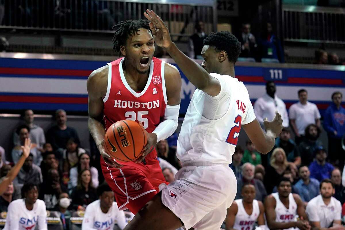 UH center Josh Carlton (25) looks for a lane to the basket as SMU's Jahmar Young Jr. defends in the first half Wednesday in Dallas. Carlton had 17 points, 11 of which came after halftime but fouled out with 2:27 left.