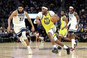 SAN FRANCISCO, CA - JANUARY 27: Kevon Looney #5 of the Golden State Warriors dribbles up the court with the ball against Karl-Anthony Towns #32 of the Minnesota Timberwolves at Chase Center on January 27, 2022 in San Francisco, California. NOTE TO USER: User expressly acknowledges and agrees that, by downloading and or using this photograph, User is consenting to the terms and conditions of the Getty Images License Agreement. (Photo by Kavin Mistry/Getty Images)