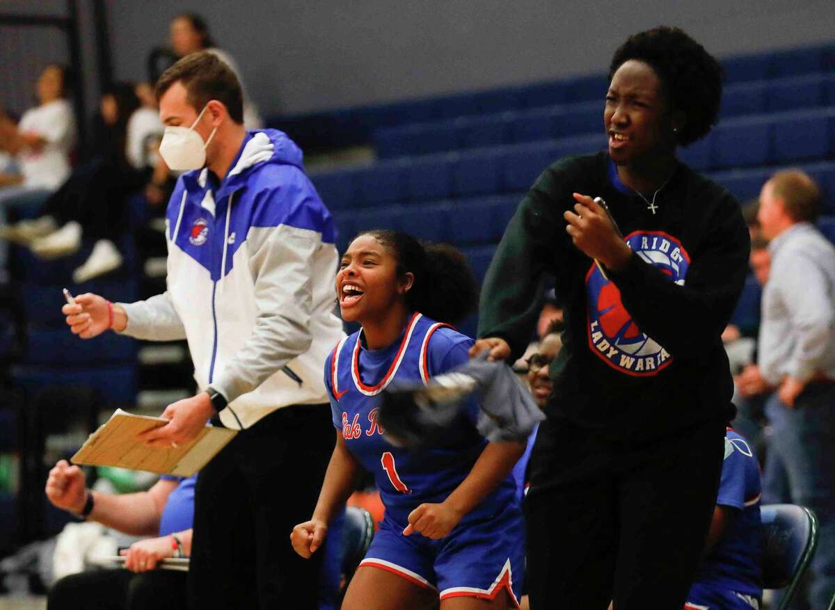 Oak Ridge players cheer during a high school basketball game at College Park High School, Wednesday, Feb. 9, 2022, in The Woodlands