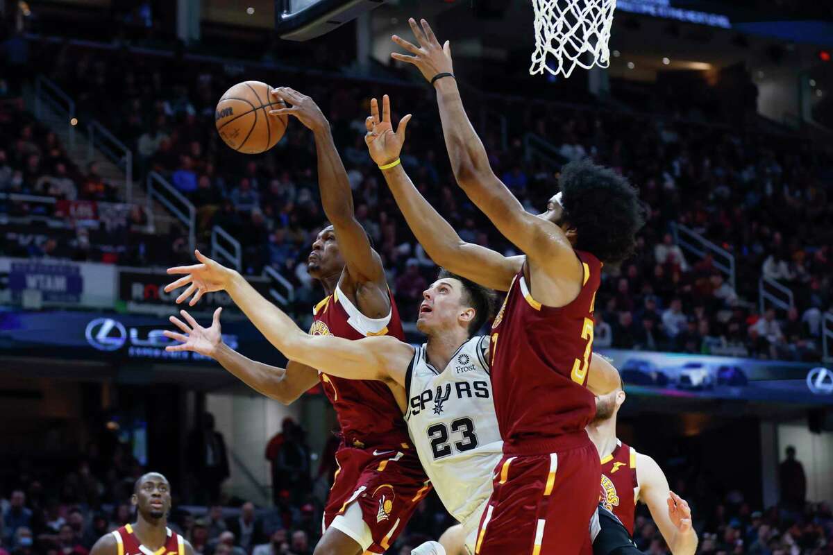 The Cavaliers’ Rajon Rondo (1) and Jarrett Allen (31) battle the Spurs’ Zach Collins (23) for a rebound during the second half ofWednesday, Feb. 9, 2022, in Cleveland. The Cavaliers defeated the Spurs 105-92.