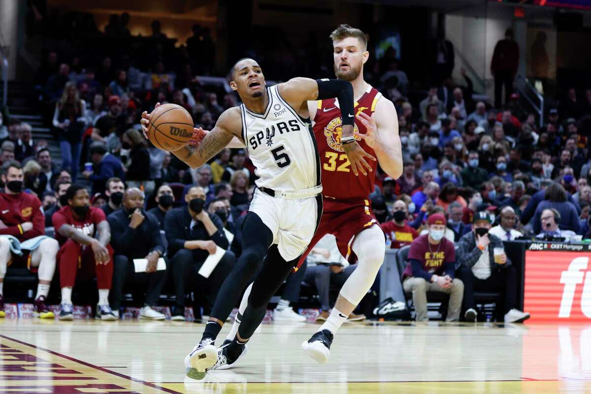The Spurs’ Dejounte Murray (5) drives against the Cavaliers’ Dean Wade (32) during the second half Wednesday, Feb. 9, 2022, in Cleveland. The Cavaliers defeated the Spurs 105-92.