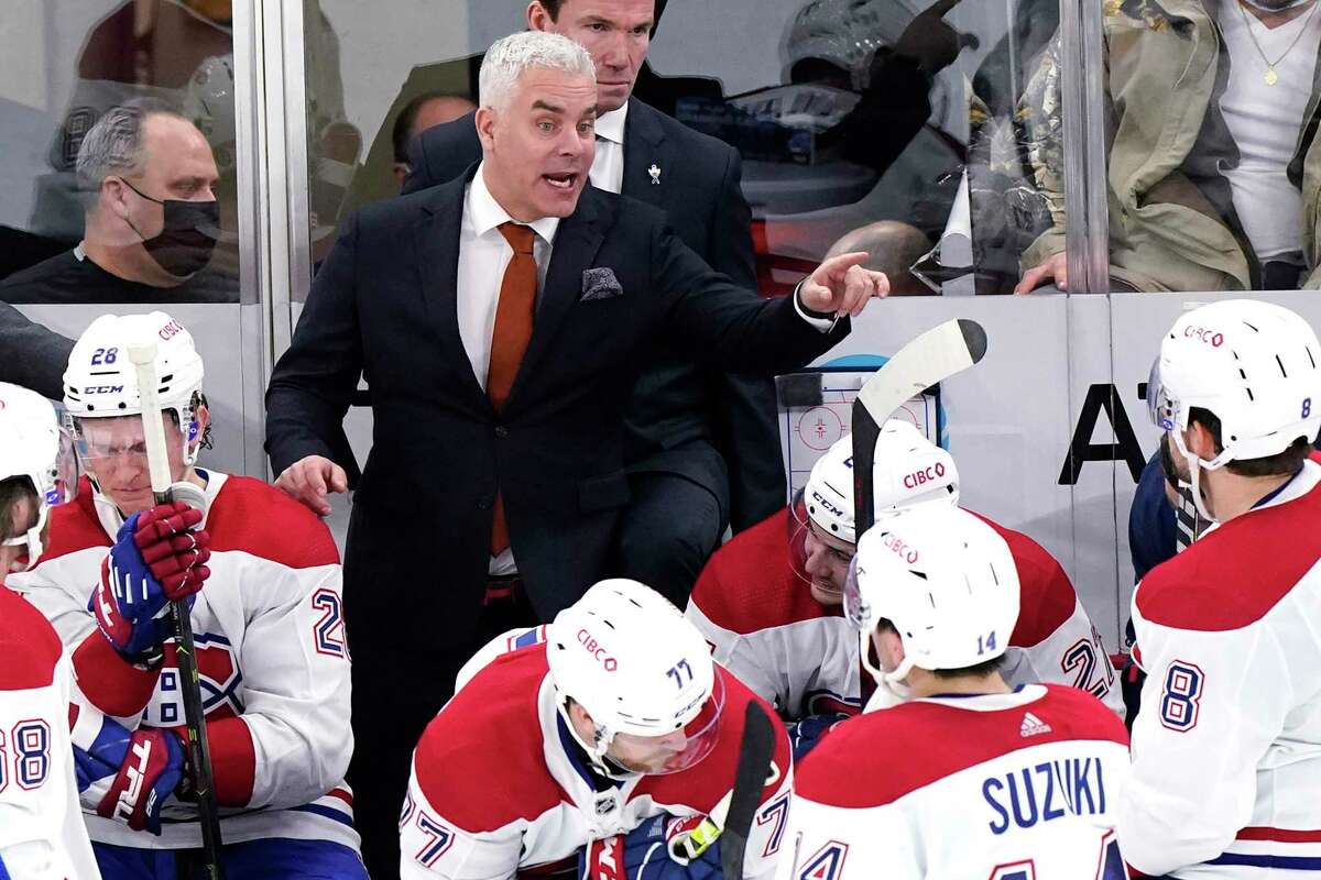 Montreal Canadiens head coach Dominique Ducharme talks to his team during overtime period of an NHL hockey game against the Chicago Blackhawks in Chicago, Thursday, Jan. 13, 2022. The Chicago Blackhawks won 3-2 in overtime. (AP Photo/Nam Y. Huh)