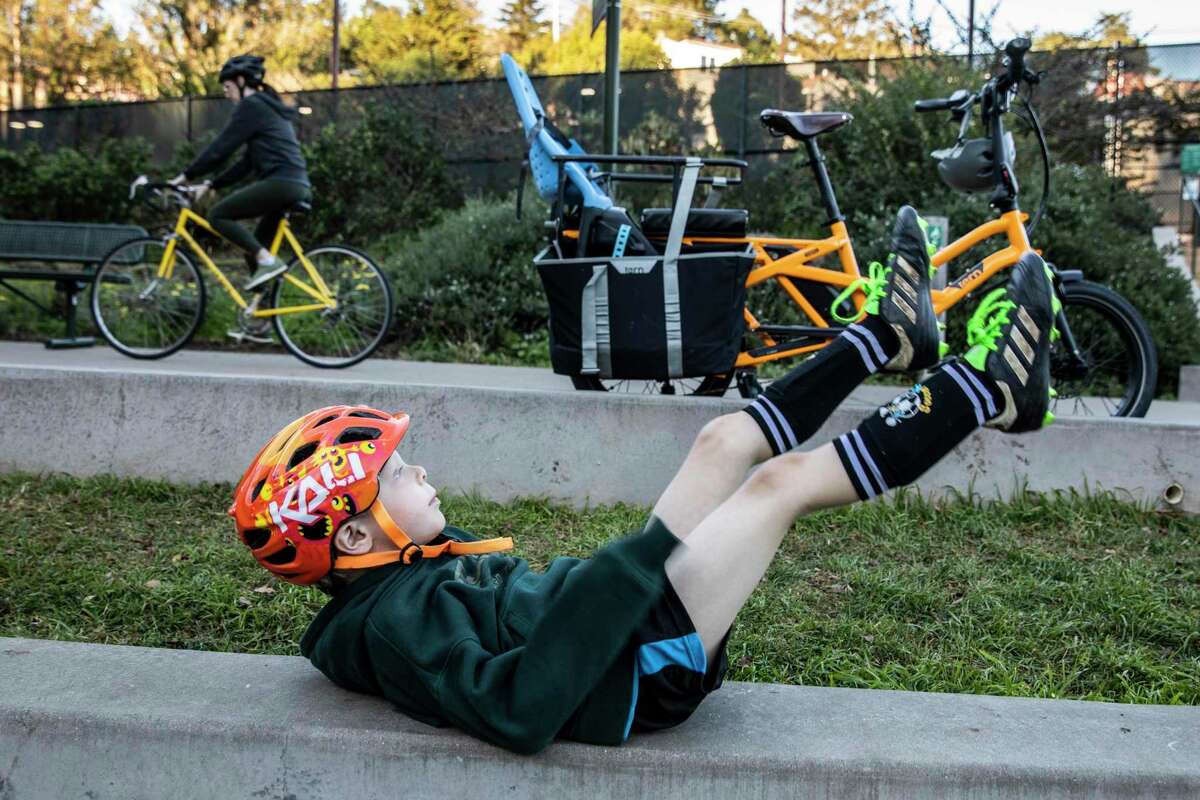 Pax, 5, lies on his back after arriving to soccer practice at Glen Canyon Park.