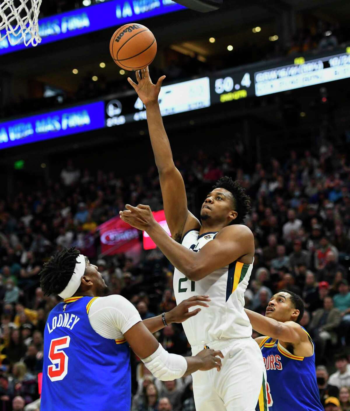 SALT LAKE CITY, UTAH - FEBRUARY 09: Hassan Whiteside #21 of the Utah Jazz shoots over Kevon Looney #5 of the Golden State Warriors during the first half of a game at Vivint Smart Home Arena on February 09, 2022 in Salt Lake City, Utah. NOTE TO USER: User expressly acknowledges and agrees that, by downloading and or using this photograph, User is consenting to the terms and conditions of the Getty Images License Agreement. (Photo by Alex Goodlett/Getty Images)